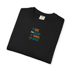 Folded black t-shirt with Eat. Sleep. Travel. Repeat." text on a white background