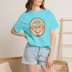Person wearing a light blue t-shirt with a graphic design, standing against a neutral background.