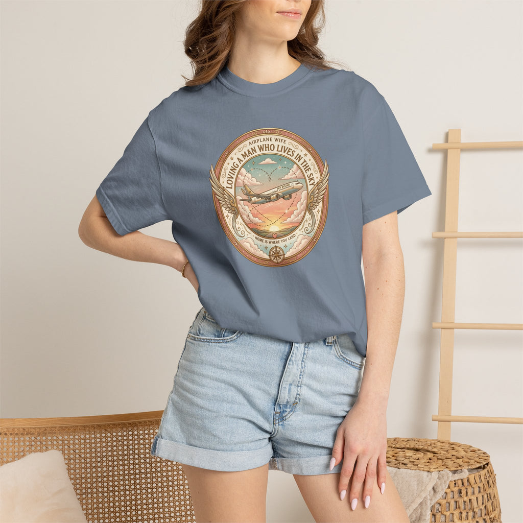Person wearing a blue t-shirt with a graphic design, standing against a neutral background.