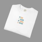 White t-shirt with 'Eat. Sleep. Travel. Repeat.' text and icons on a grey background