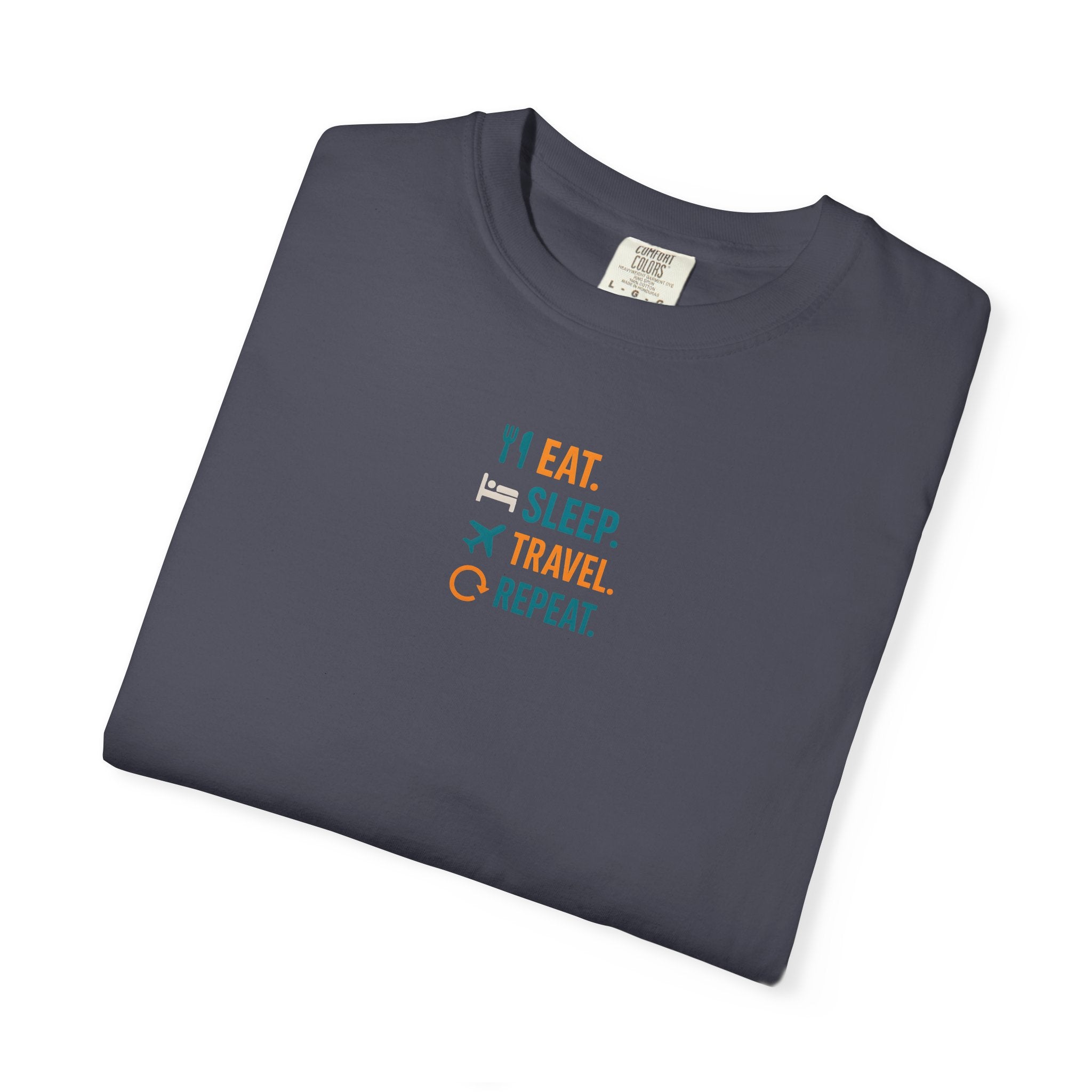 Folded navy blue t-shirt with Eat. Sleep. Travel. Repeat." text on a white background