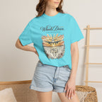 Person wearing a light blue t-shirt with a graphic design and text, standing against a neutral background.