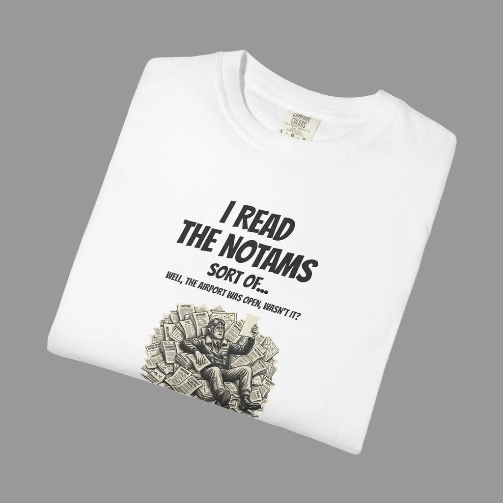 White t-shirt with black text and papers graphic on a grey background