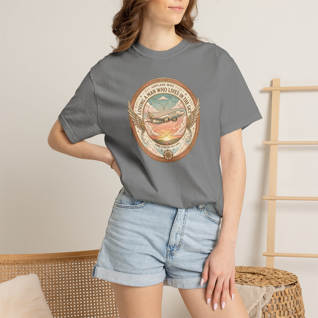 Person wearing a gray t-shirt with a graphic design, standing against a neutral background.