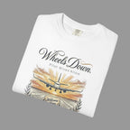 White t-shirt with airplane graphic and text on a white background