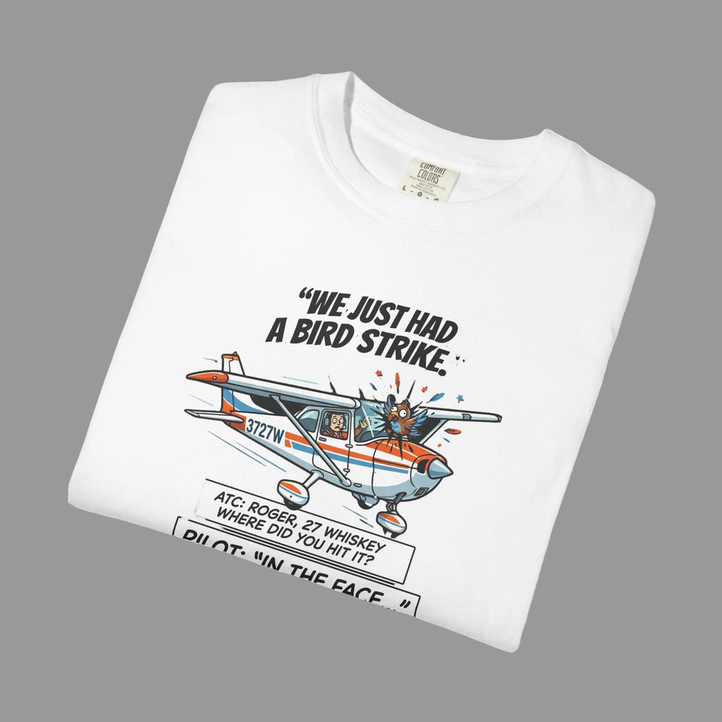 White t-shirt with airplane graphic and text on a shaded background