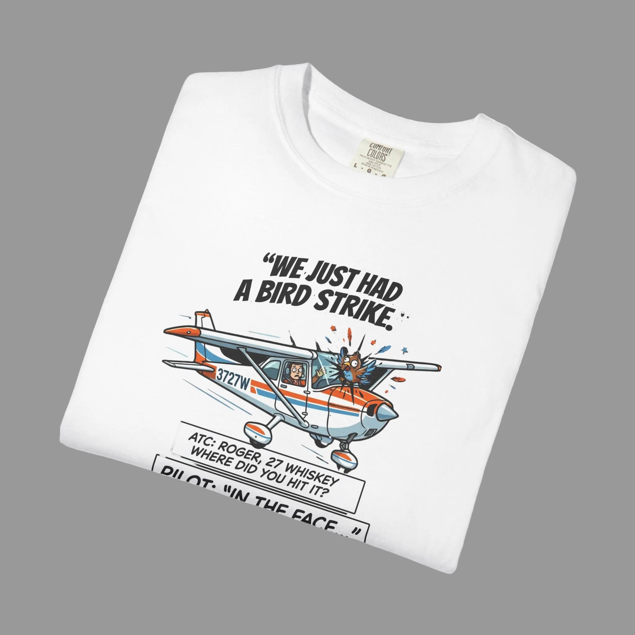 White t-shirt with airplane graphic and text on a shaded background
