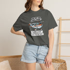 Person wearing a dark gray t-shirt with a graphic design and text, standing against a neutral background.