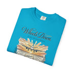 Folded blue t-shirt with airplane graphic and text on a white background